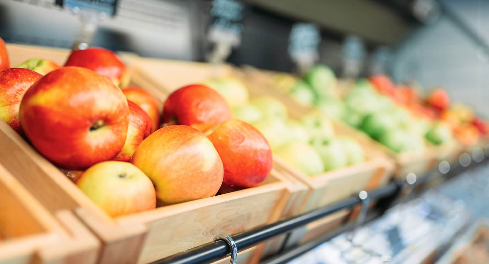 Apples in wooden crates on the shop's fruit display