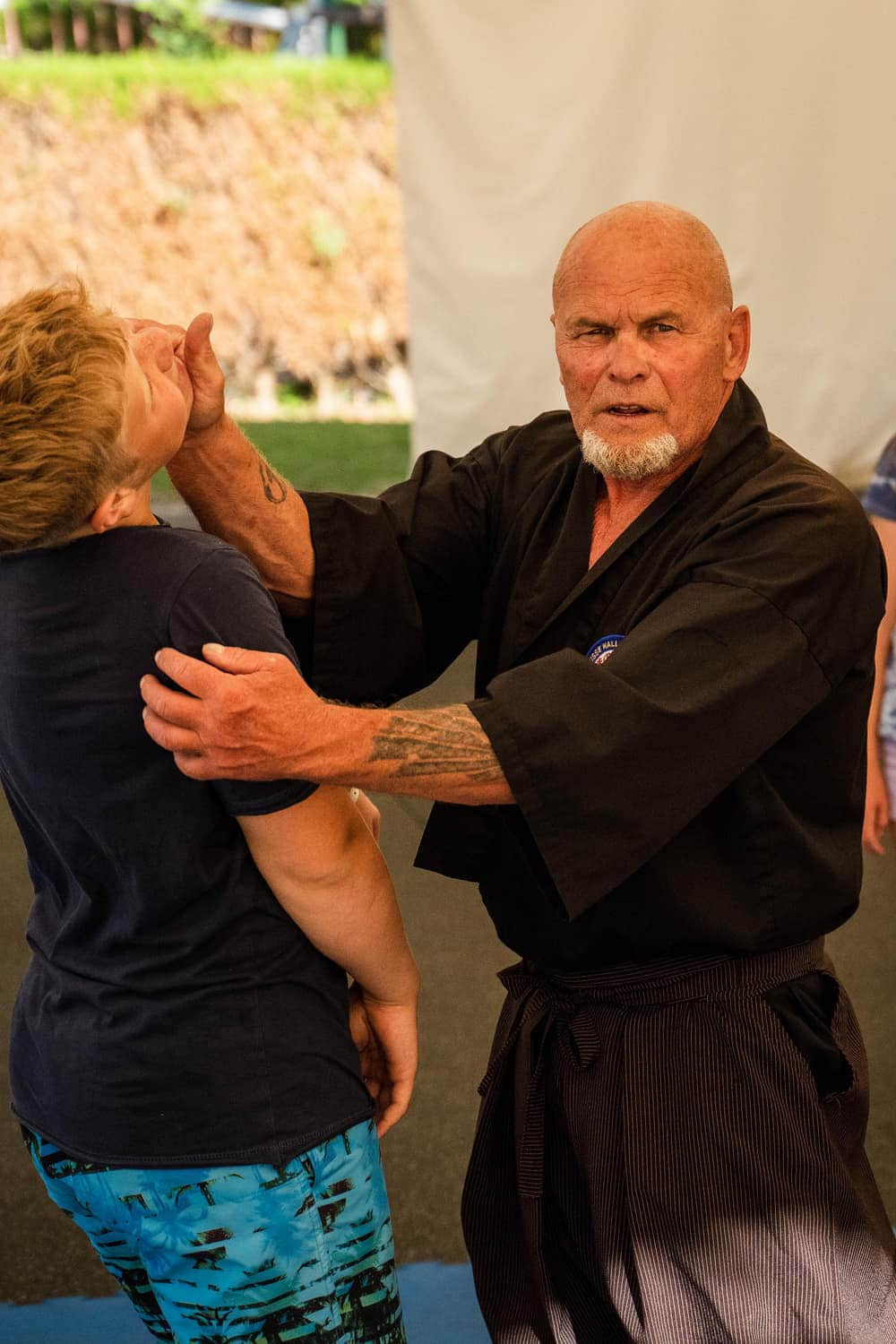 Kampfsporttrainer beim Üben mit einer Teilnehmerin