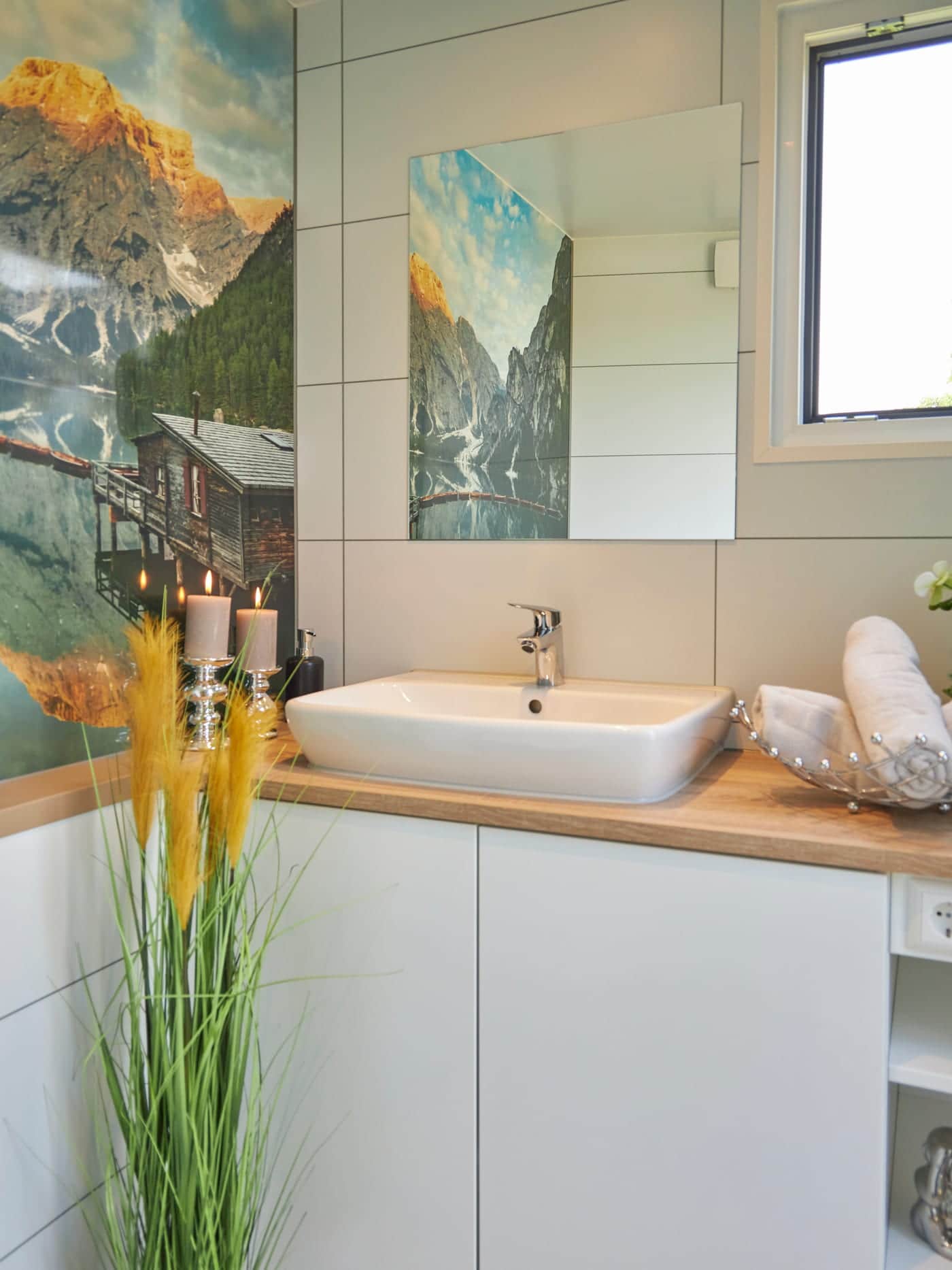 Washbasin with mirror and wooden shelf in a sanitary cabin